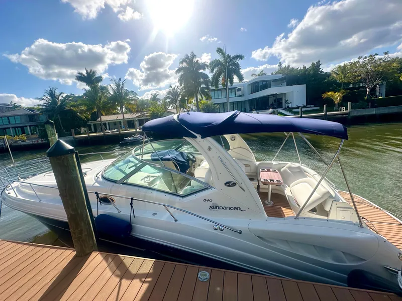 Slide: The Image of 2008 Sea Ray 420 Sundancer yacht docked under sunny skies with palm trees. - 9