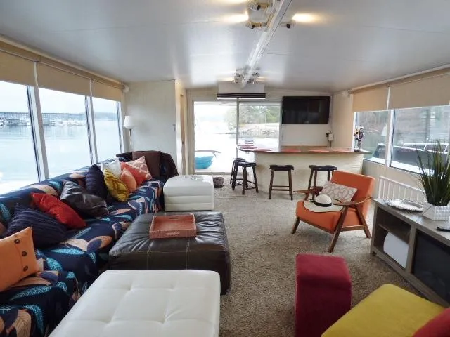 Slide: The Image of Luxurious Stardust Cruisers 18x83 houseboat interior with modern decor and panoramic windows, year 2000. - 12