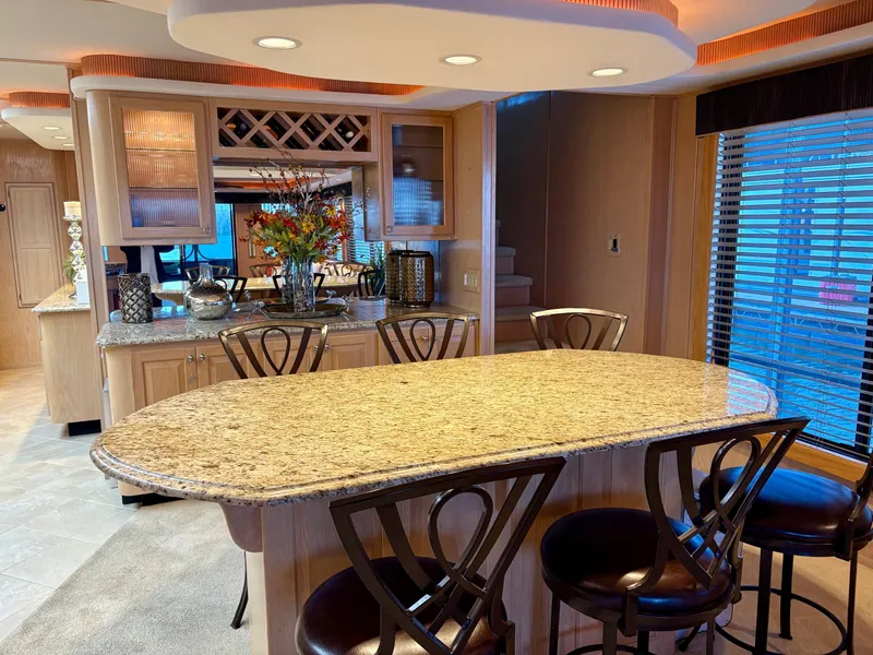Slide: The Image of Luxurious kitchen interior of 2000 Stardust Cruisers 18x83 houseboat with granite countertops and elegant seating. - 4
