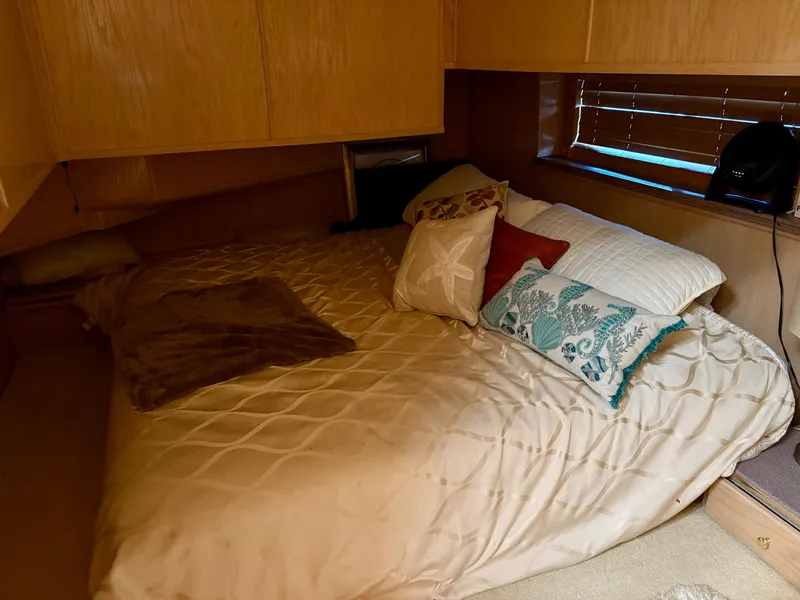 Slide: The Image of Cozy bedroom in 2000 Stardust Cruisers 18x83 houseboat with decorative pillows. - 6
