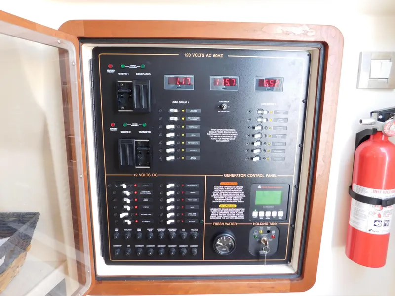 Slide: The Image of Electrical control panel on a 2018 Grady-White Freedom 375 boat, featuring various switches and gauges. - 11