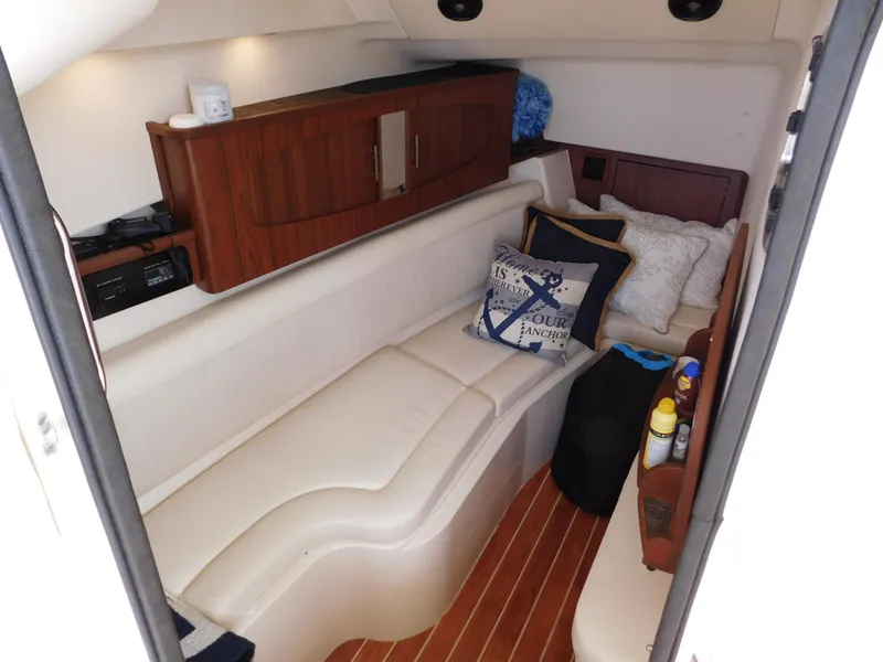 Slide: The Image of 2018 Grady-White Freedom 375 cabin interior with cozy seating and wooden cabinetry. - 18