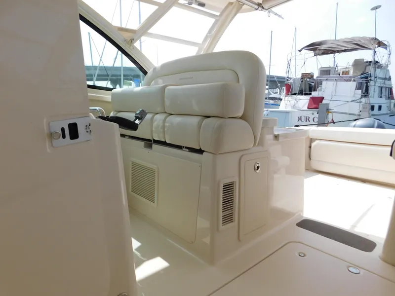 Slide: The Image of 2018 Grady-White Freedom 375 boat interior with cushioned seating and control panel. - 23