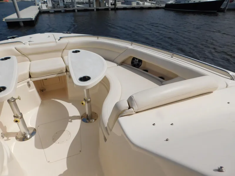 Slide: The Image of 2018 Grady-White Freedom 375 boat interior with seating and tables, docked at marina. - 26
