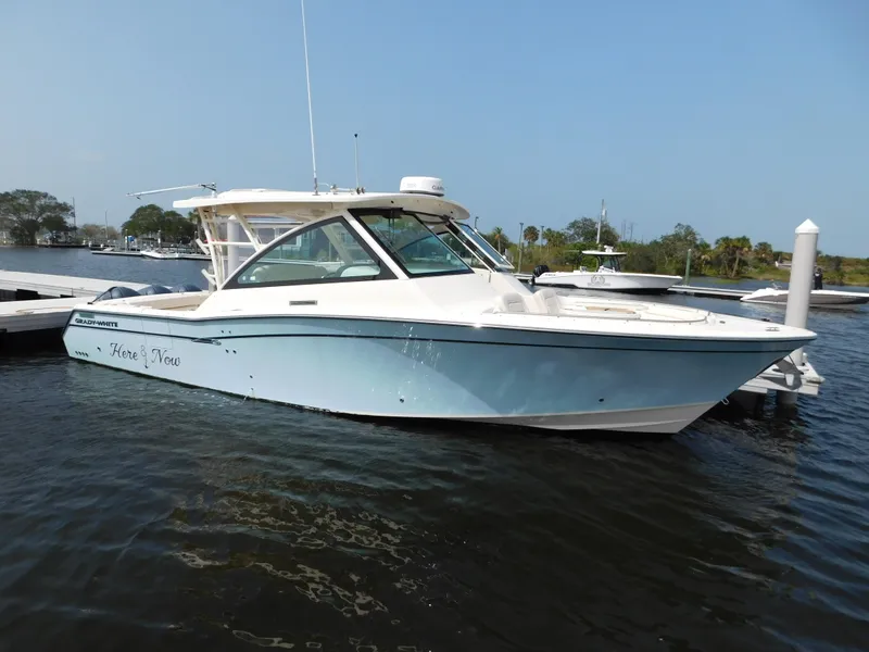 Slide: The Image of 2018 Grady-White Freedom 375 boat docked on calm water under clear blue sky. - 3