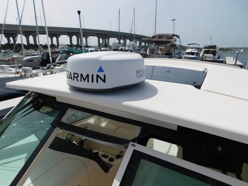 Slide: The Image of 2018 Grady-White Freedom 375 boat with Garmin radar, docked near a bridge. - 31
