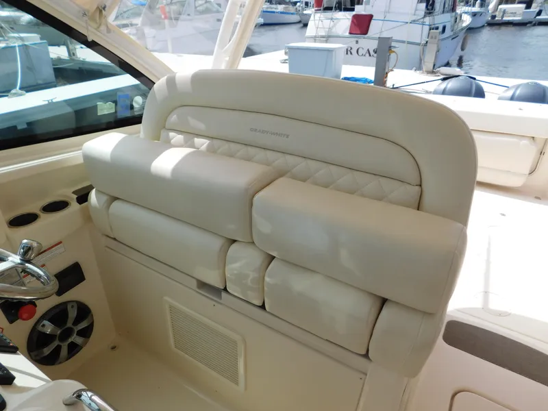 Slide: The Image of 2018 Grady-White Freedom 375 boat interior with beige seating and control panel. - 44