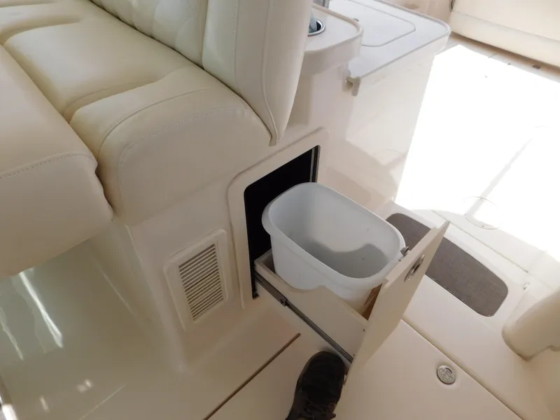 Slide: The Image of 2018 Grady-White Freedom 375 interior with pull-out storage compartment and white seating. - 46