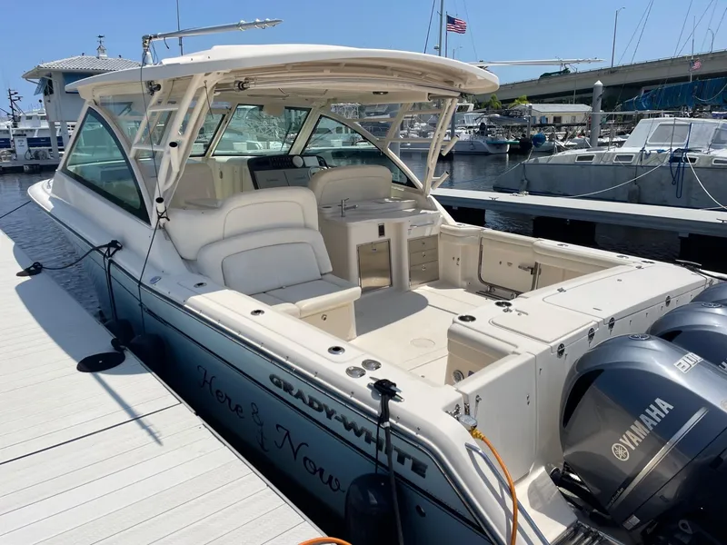 Slide: The Image of 2018 Grady-White Freedom 375 boat docked, featuring spacious seating and dual Yamaha engines. - 5