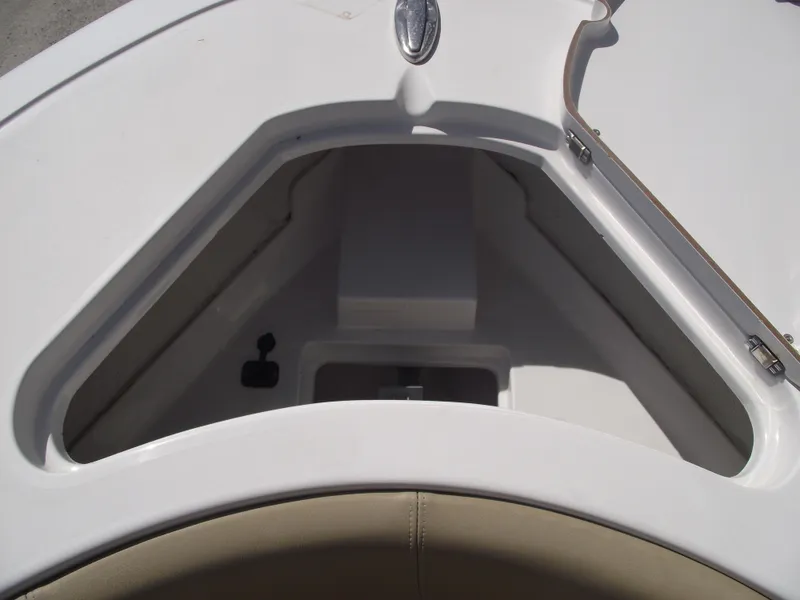 Slide: The Image of 2016 Sportsman Open 232 Center Console boat storage compartment, white interior. - 10