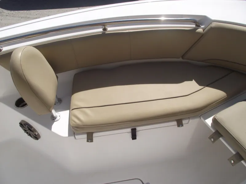 Slide: The Image of 2016 Sportsman Open 232 Center Console boat with beige seating and stainless steel rail. - 11