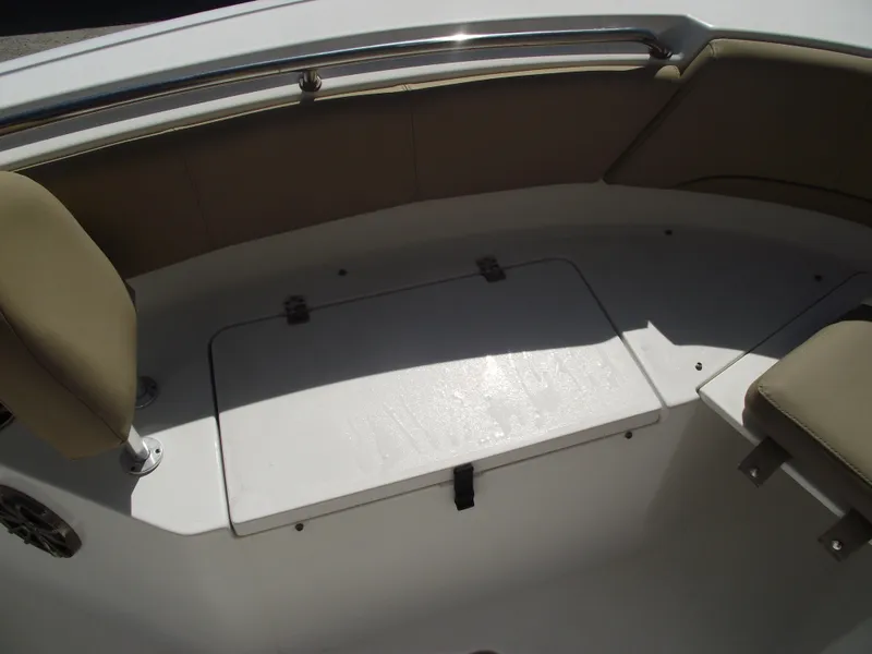 Slide: The Image of 2016 Sportsman Open 232 Center Console boat interior seating and storage area. - 12