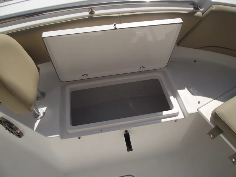 Slide: The Image of 2016 Sportsman Open 232 Center Console boat storage compartment open. - 13
