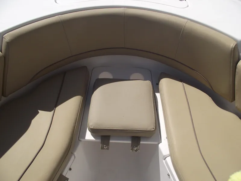 Slide: The Image of 2016 Sportsman Open 232 Center Console boat seating area with tan cushions. - 14