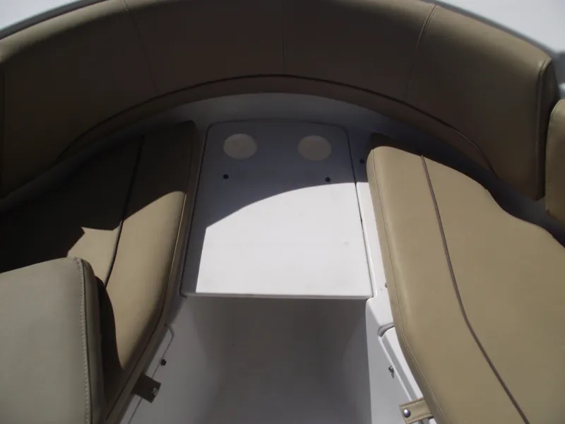Slide: The Image of 2016 Sportsman Open 232 Center Console boat interior with tan seating and white deck. - 15