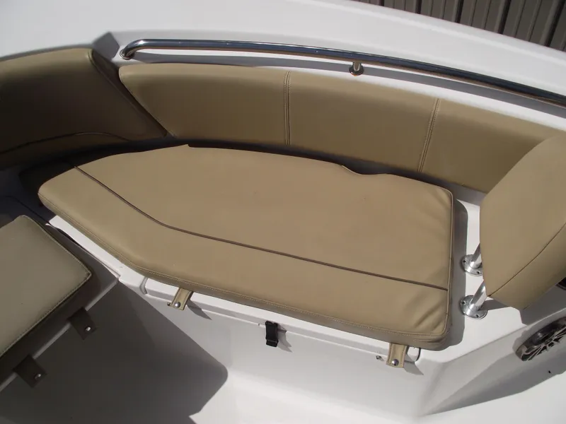Slide: The Image of 2016 Sportsman Open 232 Center Console boat with tan cushioned seating. - 16