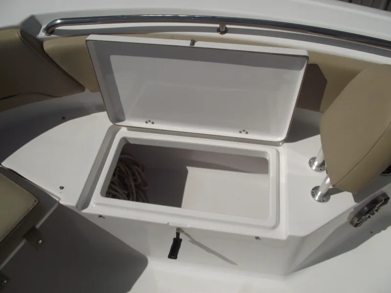 Slide: The Image of Open storage compartment on 2016 Sportsman Open 232 Center Console boat. - 18