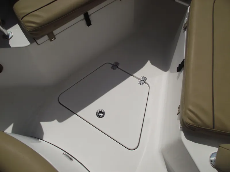 Slide: The Image of 2016 Sportsman Open 232 Center Console boat interior with storage hatch and cushioned seating. - 21