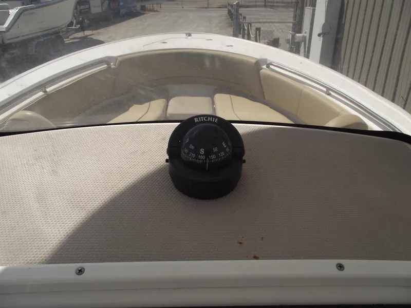 Slide: The Image of 2016 Sportsman Open 232 Center Console boat with Ritchie compass on dashboard. - 27