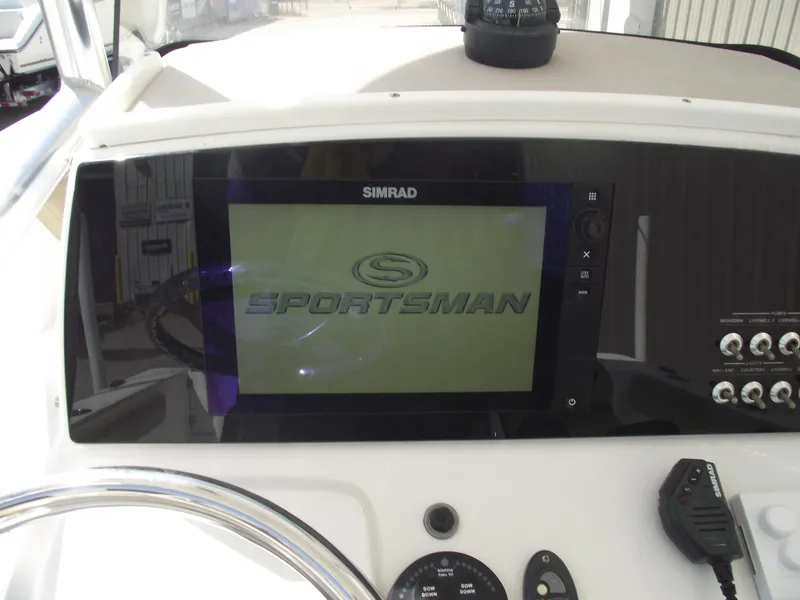 Slide: The Image of 2016 Sportsman Open 232 Center Console dashboard with Simrad display and controls. - 29