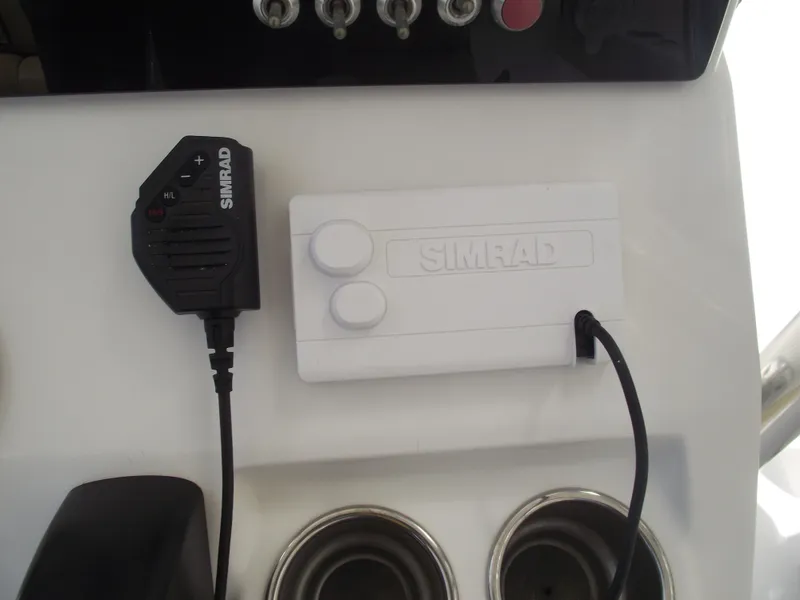 Slide: The Image of Simrad marine equipment on 2016 Sportsman Open 232 Center Console boat dashboard. - 30