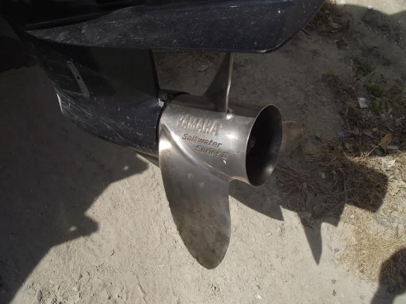 Slide: The Image of Propeller of a 2016 Sportsman Open 232 Center Console boat on sandy ground. - 4