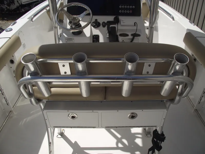 Slide: The Image of 2016 Sportsman Open 232 Center Console boat interior with rod holders and steering wheel. - 40