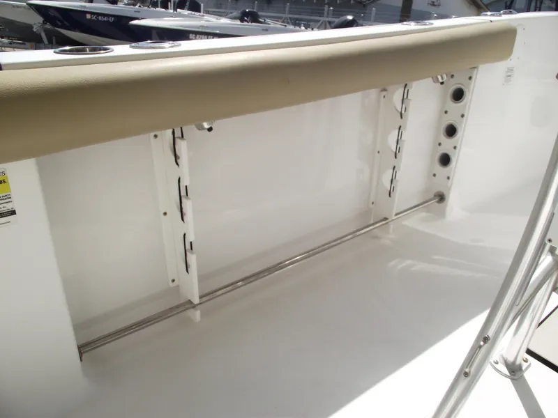 Slide: The Image of 2016 Sportsman Open 232 Center Console interior with rod holders and cushioned seating. - 42