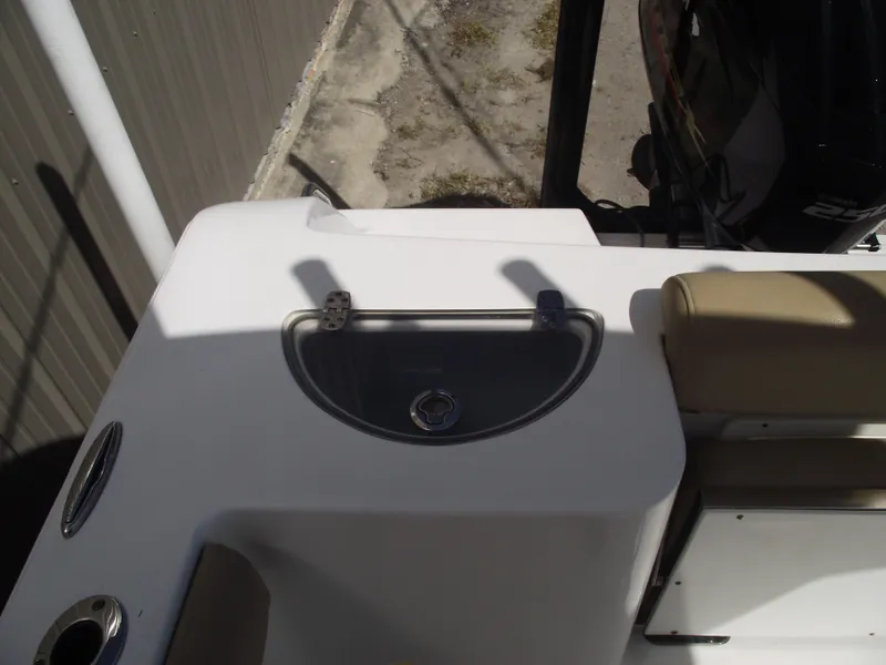 Slide: The Image of 2016 Sportsman Open 232 Center Console boat interior with seating and storage compartment. - 43