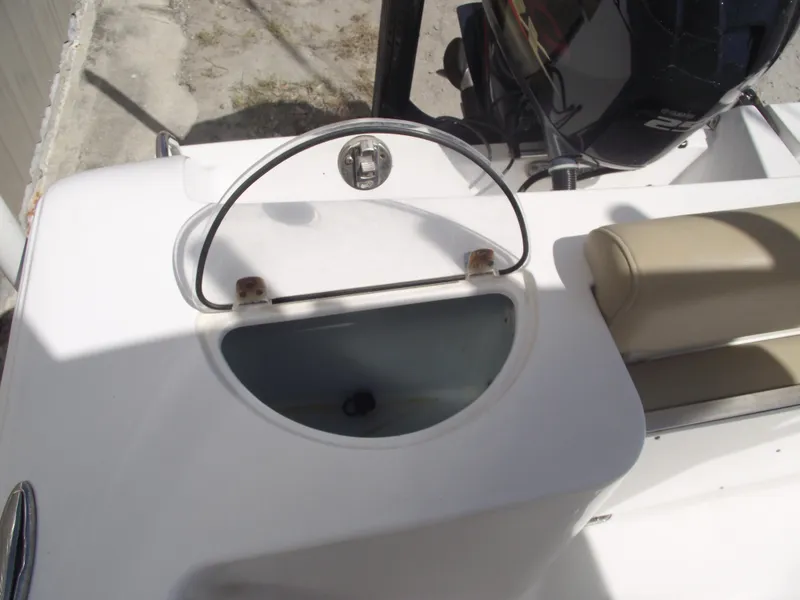 Slide: The Image of 2016 Sportsman Open 232 Center Console boat with open storage compartment and seating. - 44