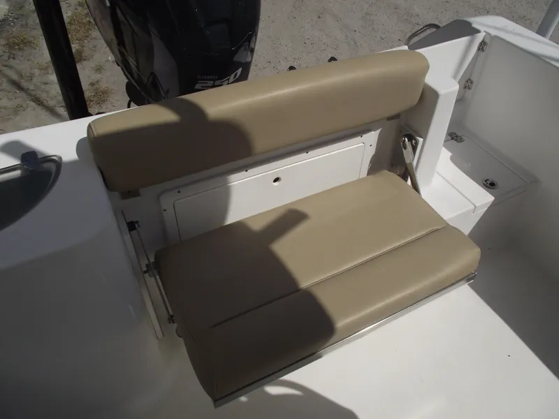 Slide: The Image of 2016 Sportsman Open 232 Center Console boat seat, beige upholstery, rear view. - 46