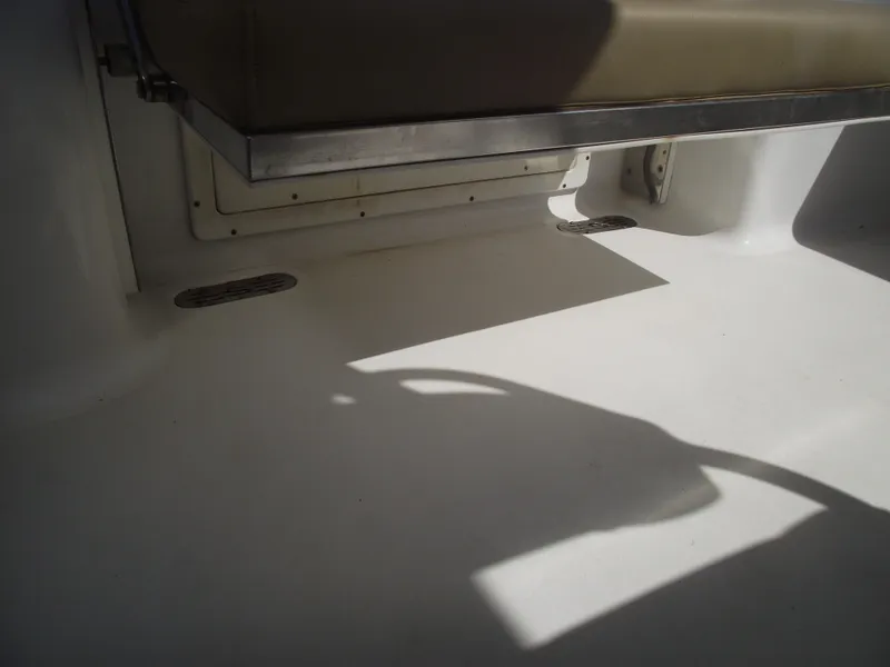 Slide: The Image of 2016 Sportsman Open 232 Center Console interior with seating and shadowed deck area. - 47