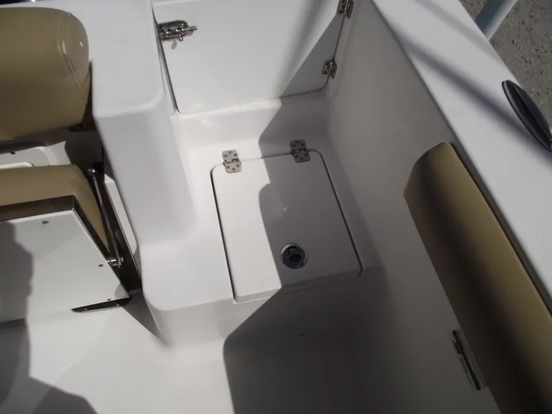 Slide: The Image of 2016 Sportsman Open 232 Center Console boat interior with storage compartment and seating. - 48