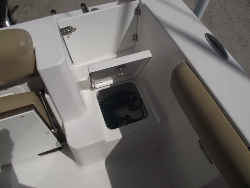 Slide: The Image of 2016 Sportsman Open 232 Center Console boat interior with storage compartment open. - 49