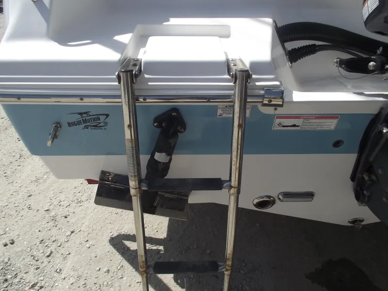 Slide: The Image of 2016 Sportsman Open 232 Center Console boat with rear ladder and blue hull detail. - 6