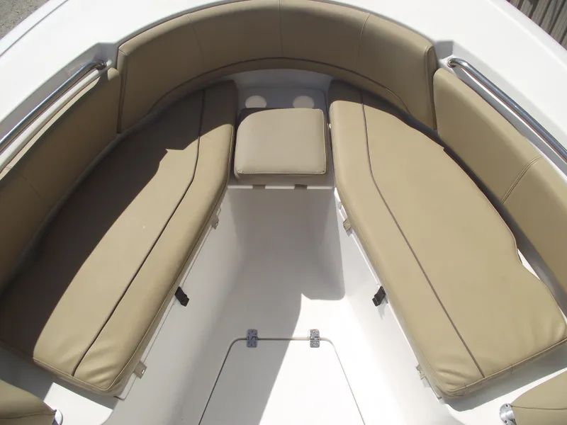Slide: The Image of 2016 Sportsman Open 232 Center Console boat interior with tan cushioned seating. - 8