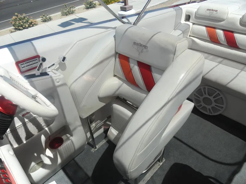 Slide: The Image of 2003 Cobra 270 Razor boat interior with white and orange seating. - 12