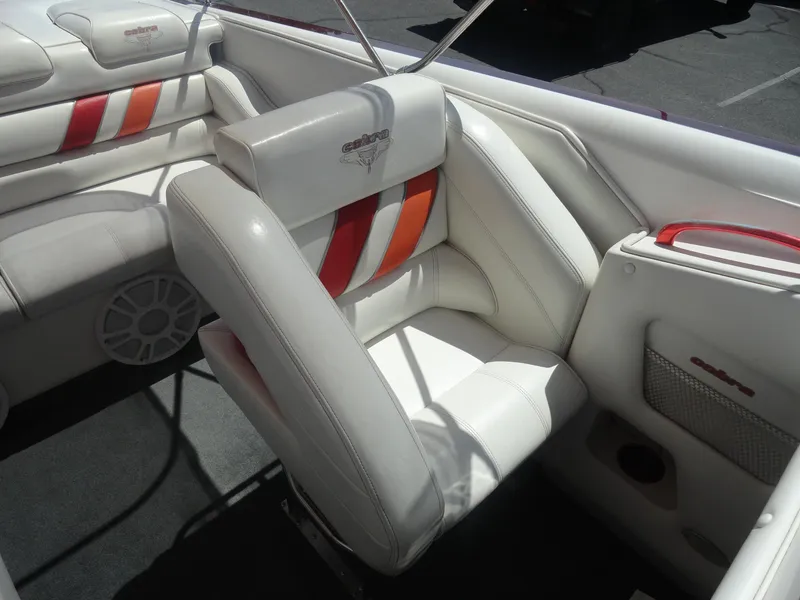 Slide: The Image of 2003 Cobra 270 Razor boat interior with white and red-striped seating. - 14