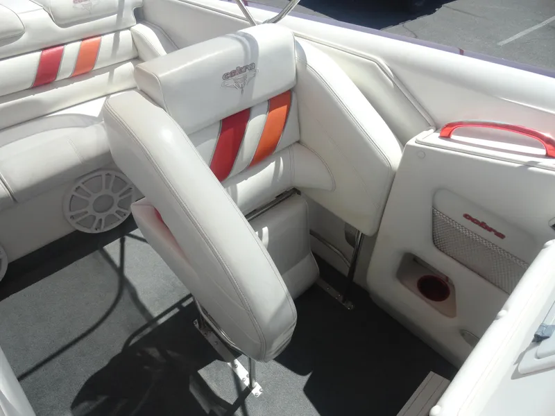 Slide: The Image of 2003 Cobra 270 Razor Mid-Cabin Open Bow interior with white and red seating. - 15