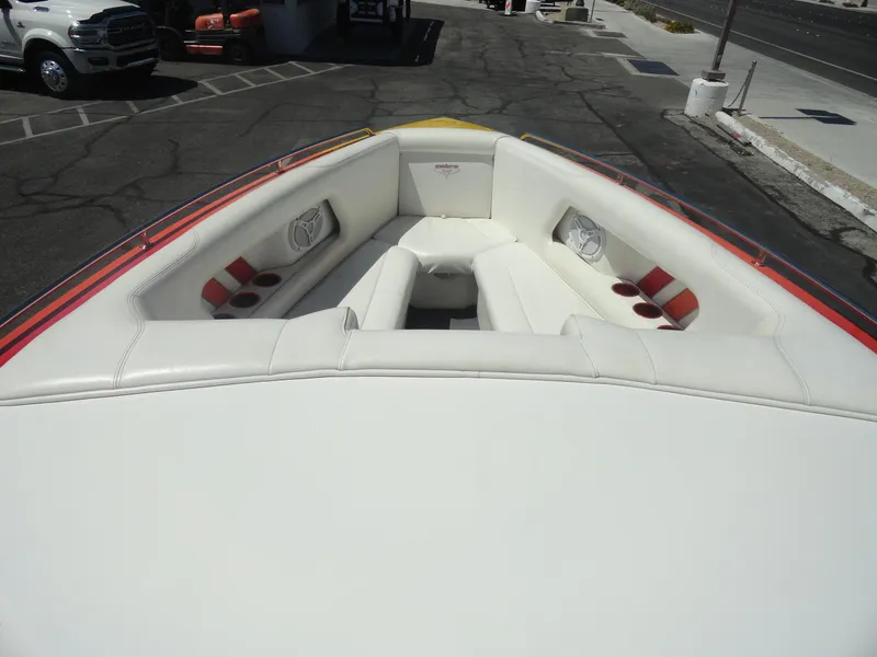 Slide: The Image of 2003 Cobra 270 Razor Mid-Cabin Open Bow with white seating and cup holders. - 19