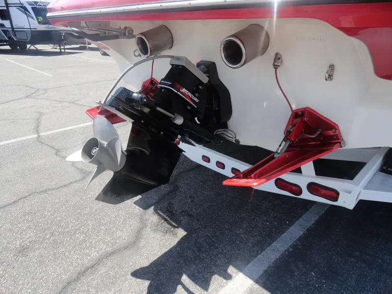 Slide: The Image of 2003 Cobra 270 Razor Mid-Cabin Open Bow boat stern with dual exhaust and propeller. - 25