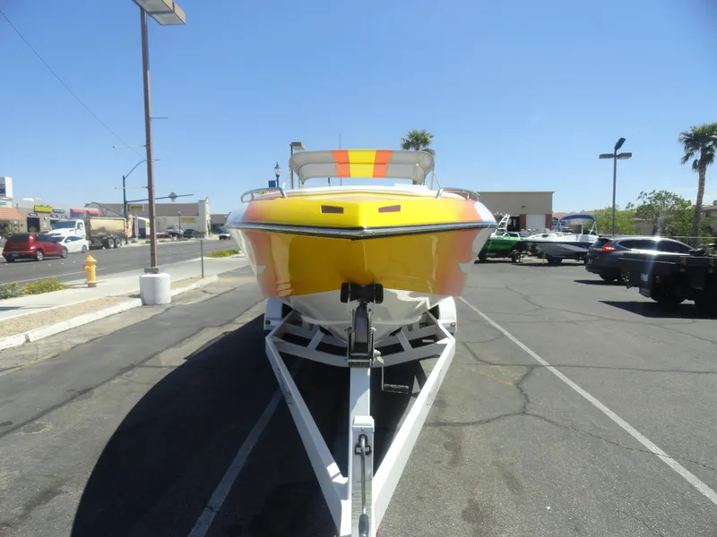 Slide: The Image of 2003 Cobra 270 Razor Mid-Cabin Open Bow boat on trailer in parking lot. - 3