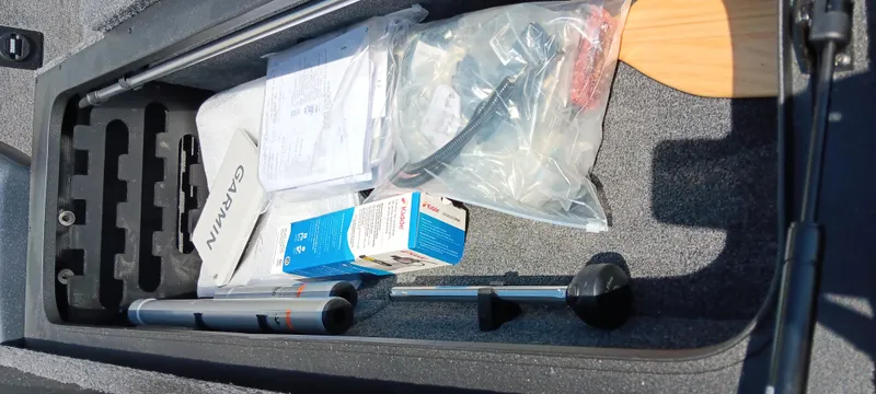 Slide: The Image of Storage compartment of 2025 Tracker Savage 215 with boating accessories and equipment. - 20