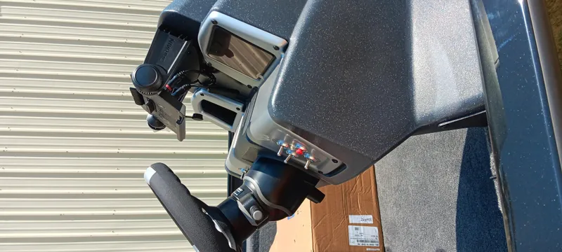 Slide: The Image of Control panel of 2025 Tracker Savage 215 boat with steering wheel and electronic displays. - 22