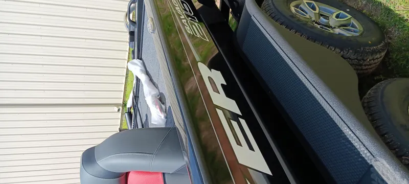 Slide: The Image of 2025 Tracker Savage 215 boat with sleek design and modern features. - 24