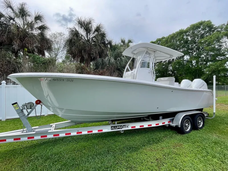 The Image of 2022 Front Runner 26 Center Console boat on trailer, parked on grass. - 0