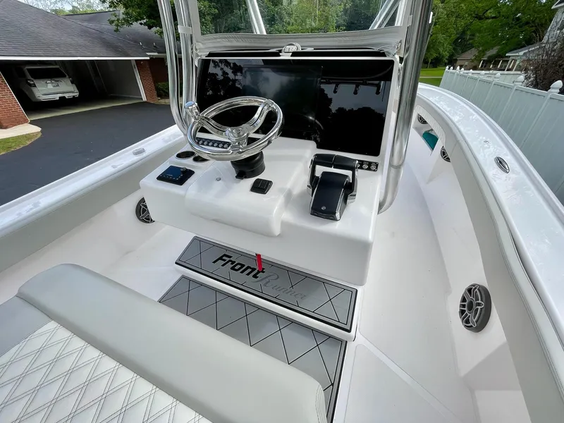 Slide: The Image of 2022 Front Runner 26 Center Console boat interior with steering wheel and dashboard. - 16