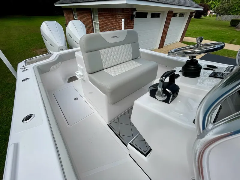 Slide: The Image of 2022 Front Runner 26 Center Console boat interior with steering wheel and controls. - 17