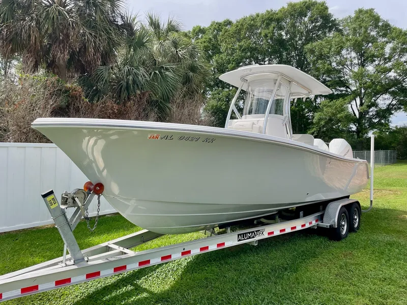 Slide: The Image of 2022 Front Runner 26 Center Console boat on trailer, parked on grass. - 2