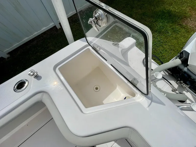 Slide: The Image of 2022 Front Runner 26 Center Console boat with open storage compartment. - 22